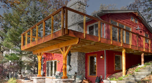 Large wood deck with attractive dining area underneath in Elkhorn